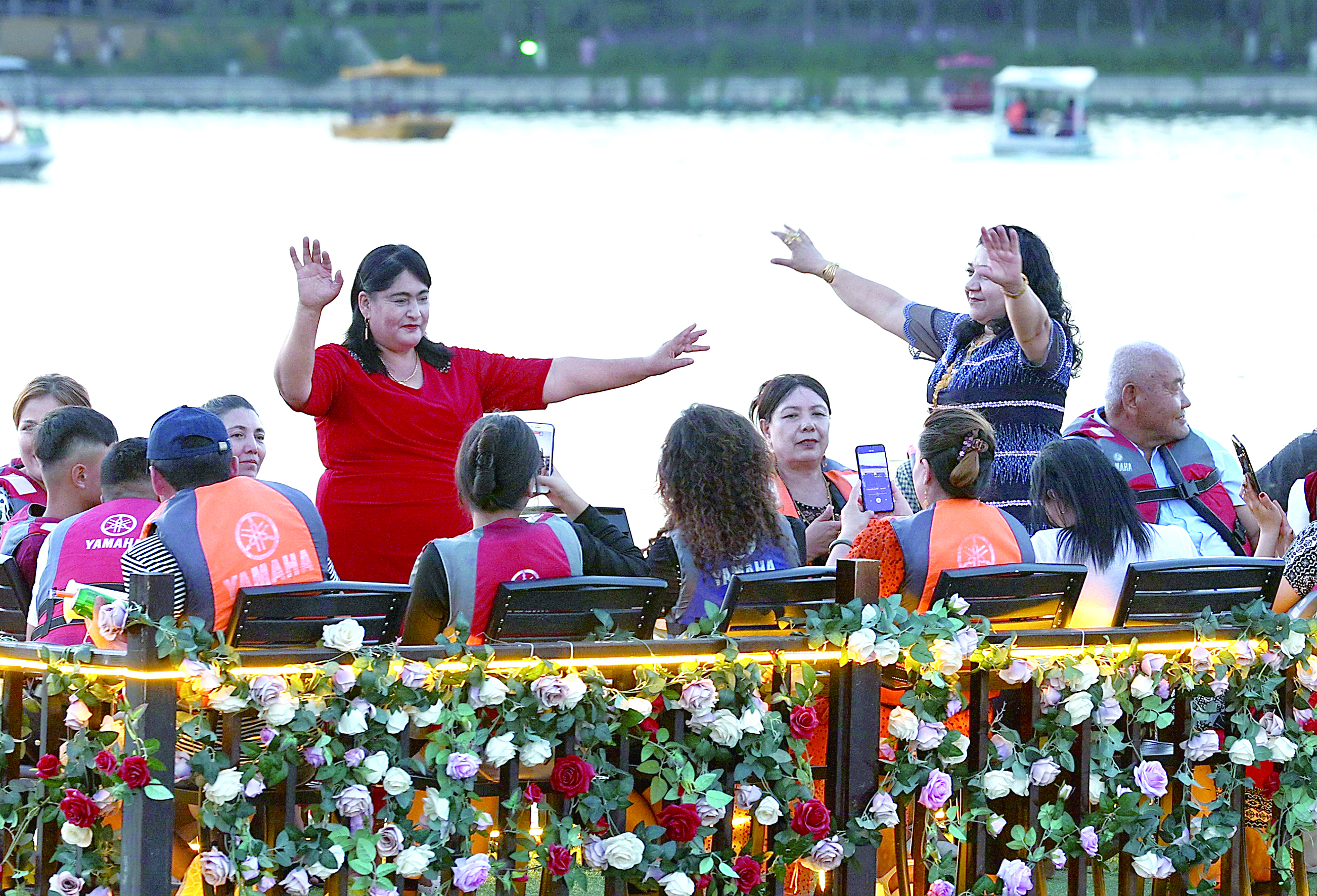 在巩留县蝶湖，伴随着音乐，游客在游船上翩翩起舞。.jpg
